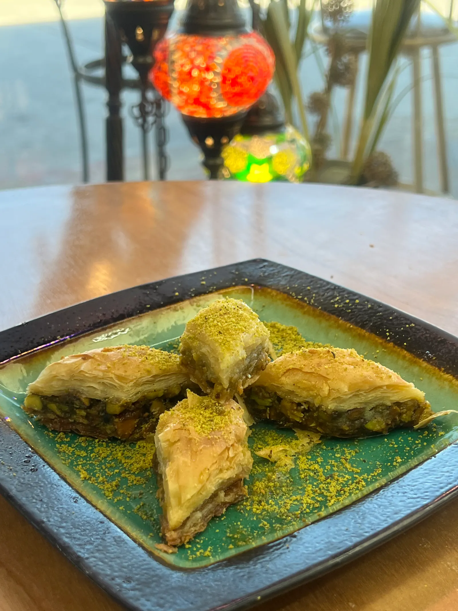 Fresh pistachio baklava on a plate at Al-Baghdady, an Iraqi bakery in Richardson, TX